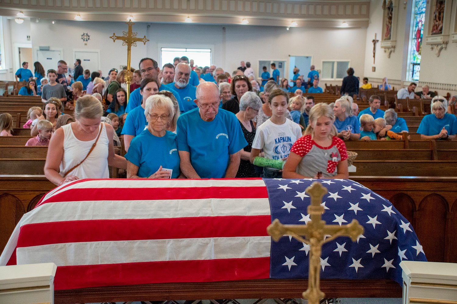 People at St. John Nepomucene Church in Pilsen, Kan., welcome the remains of Father Emil J. Kapaun and pray for his intercession Sept. 25, 2021. A candidate for sainthood, Father Kapaun died May 23, 1951, while ministering to prisoners of war during the Korean War.